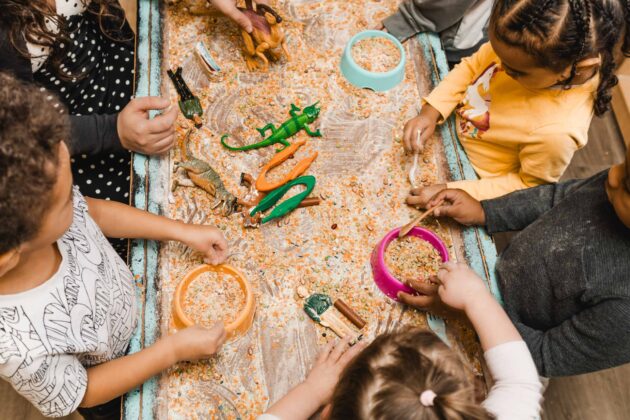 A group of children playing with plastic toys.