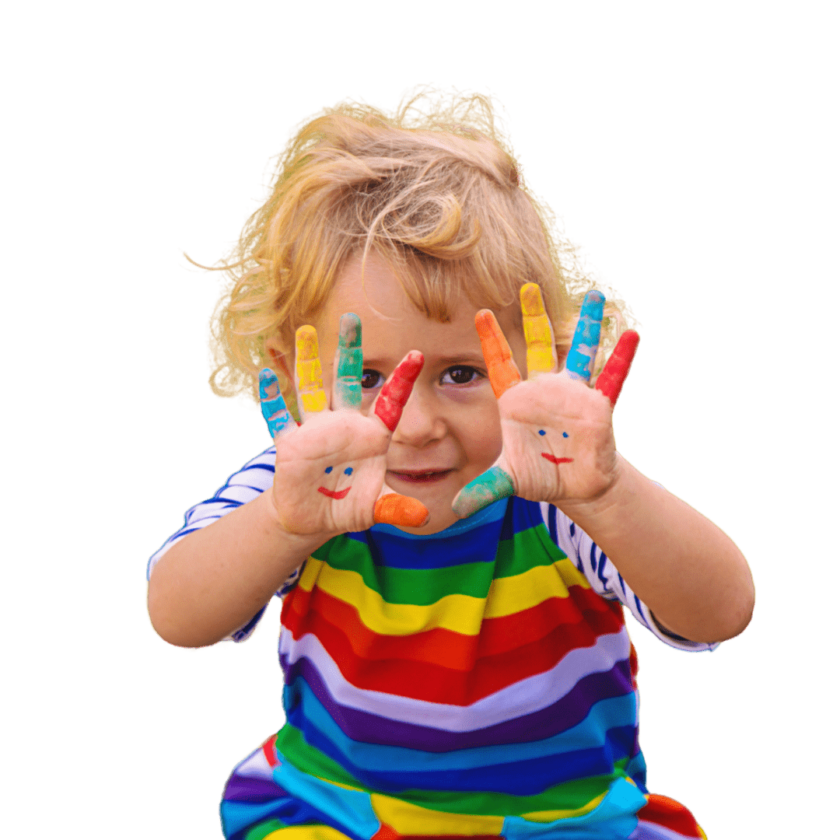 A little boy holding up his hands covered in rainbow paint.